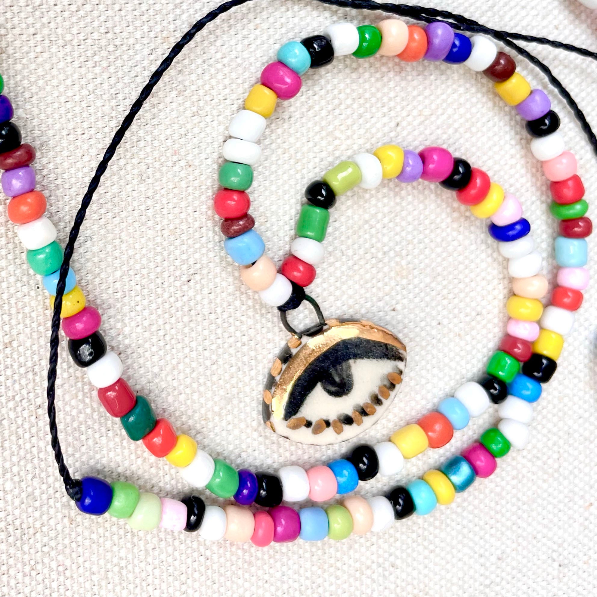 Beaded necklace with glass bobcat eye outlet